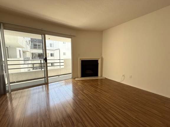A room with a fireplace and sliding glass doors.
