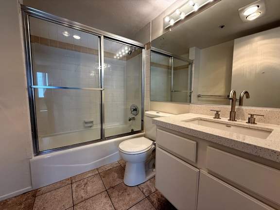 A bathroom with a toilet, sink, and shower.