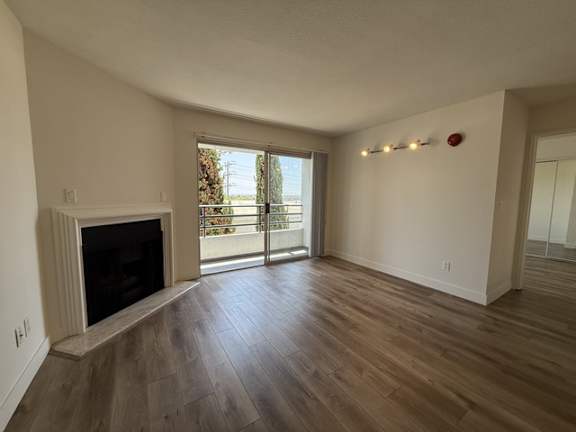 A living room with a fireplace and sliding glass doors.