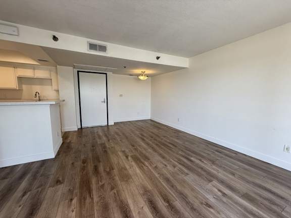 A room with wooden flooring and a white door.