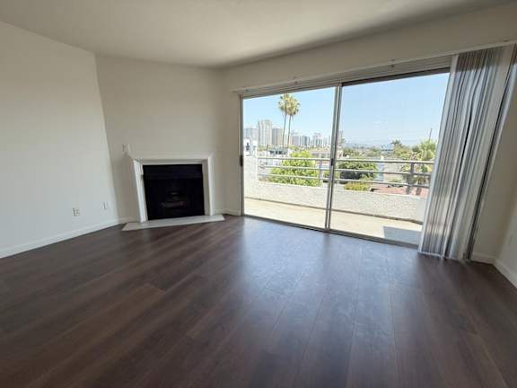 A living room with a fireplace and sliding glass doors.