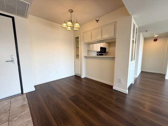 A room with wooden floors and white walls.