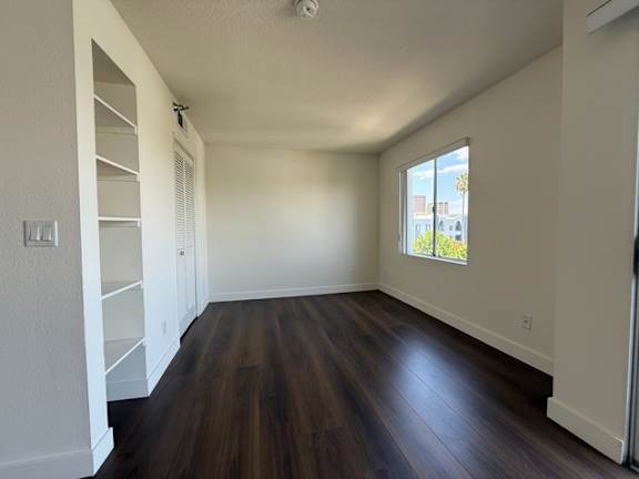 A room with wooden floors and white walls.