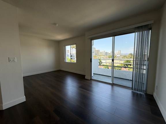 A large empty room with a view of the city.