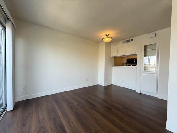 A room with wooden floors and white walls.