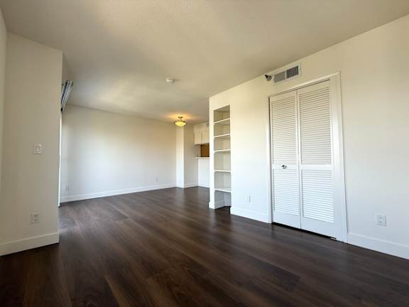 A room with wooden floors and white walls.