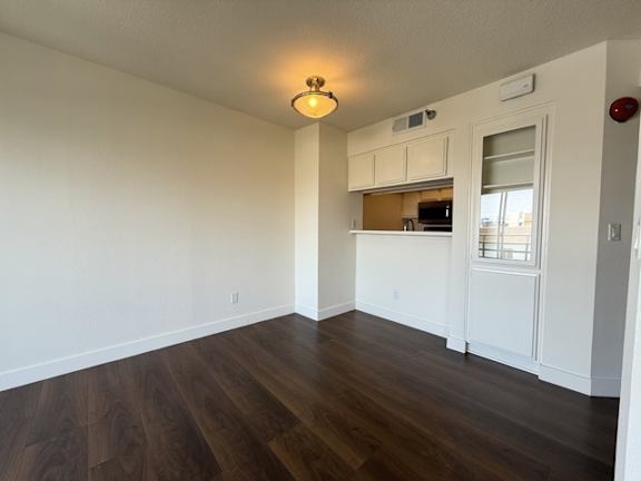 A room with wooden floors and white walls.