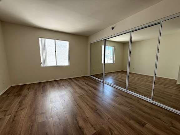 A room with wooden floors and a large mirror.