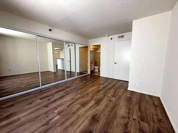 A room with wooden floors and white walls.