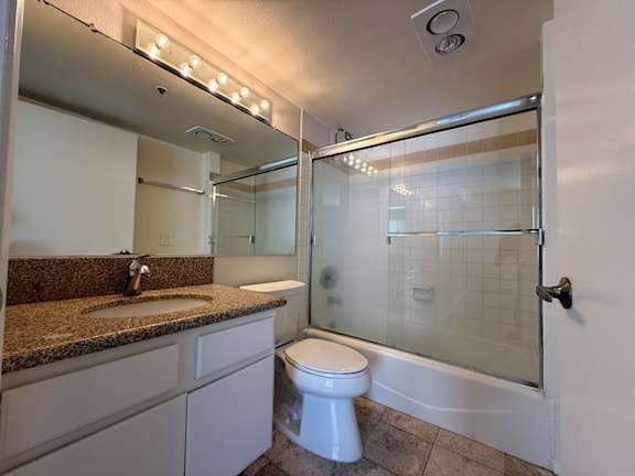A bathroom with a toilet, sink, and shower.