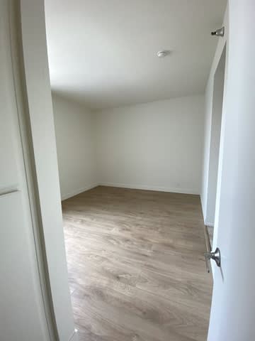 A room with white walls and wood flooring.