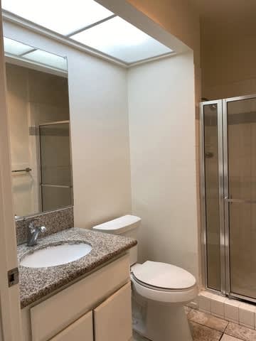 A bathroom with a sink, toilet and shower.
