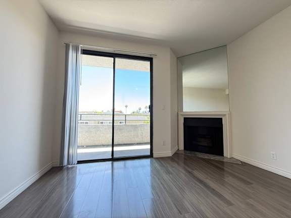 A room with a fireplace and sliding glass doors.