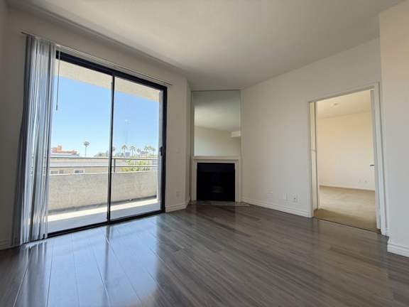 A room with a fireplace and sliding glass doors.