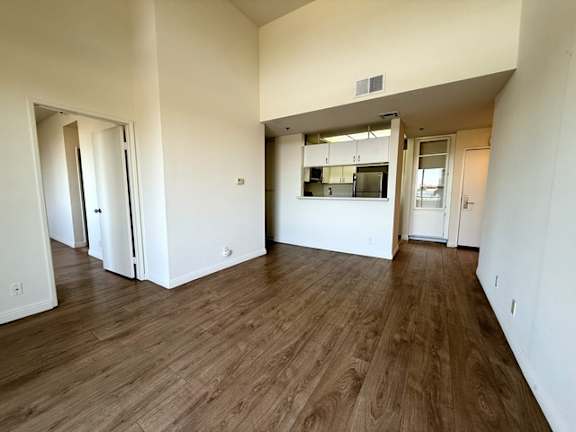 A room with wooden floors and white walls.