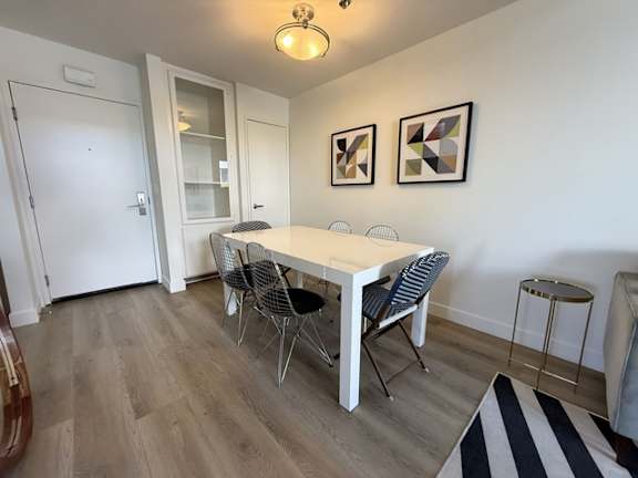 A dining room with a white table and chairs.