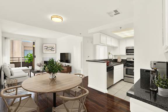 A modern kitchen with a dining table and chairs.