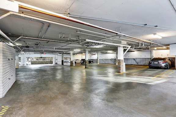 A spacious garage with concrete floors and multiple parking spaces.