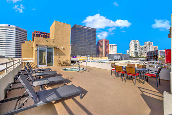 A rooftop patio with chairs and a table at Peach Tree Court, Los Angeles, CA 90024