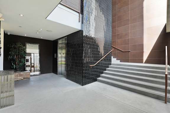 A staircase with a metal railing and elevator.