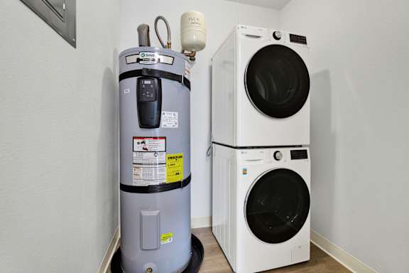 A washing machine and a water heater in a room.