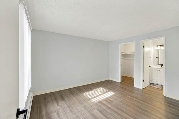 A room with a white wall and a wooden floor.
