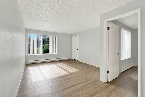 A room with wooden floors and white walls.