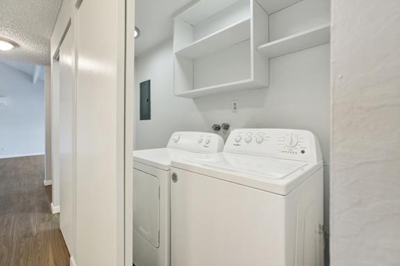 A white washing machine and dryer in a small laundry room.