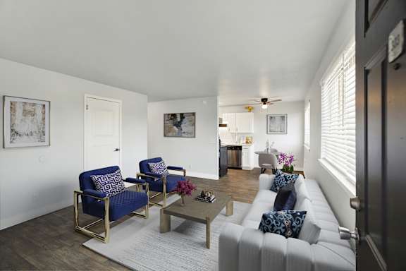A living room with a white couch and a coffee table.