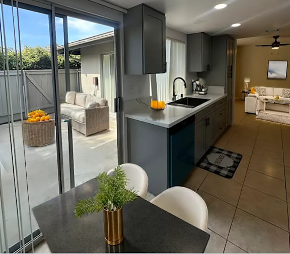 A modern kitchen with a dining table and chairs.