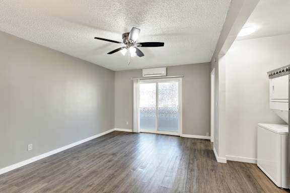A room with a ceiling fan and sliding glass doors.at Federal Apartments, California