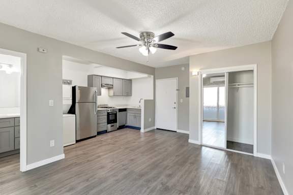 A spacious kitchen with a refrigerator, sink, and stove.at Federal Apartments, Los Angeles California