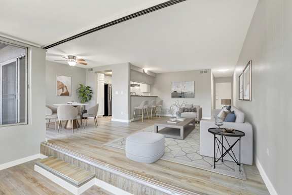 A modern living room with a dining area and a kitchen in the background.at City Park View, California, 90057
