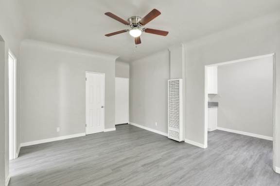 A room with a ceiling fan and wood flooring.at Barton Apartments, Los Angeles, 90038