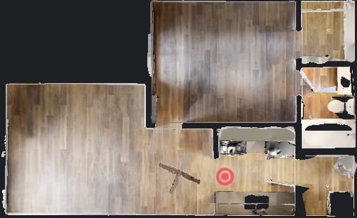 A top down view of a room with a red target in the middle.