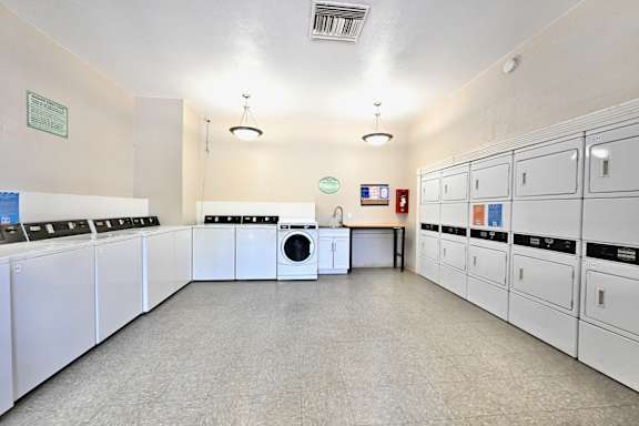 A laundry room with washers and dryers.