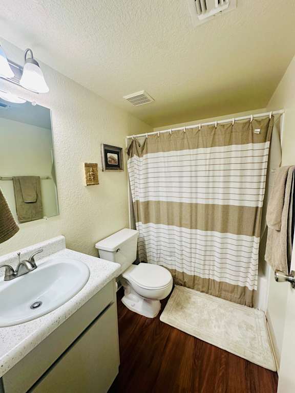 Bathroom with toilet, sink, and shower curtain at Mountain Vista, Arizona