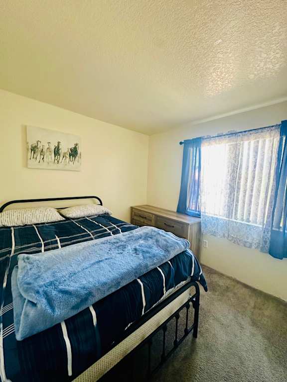 Bedroom with a bed and window with curtains at Mountain Vista, Arizona, 85635