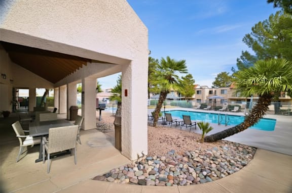 A patio area with a table and chairs is shown.