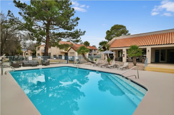 A large swimming pool in the middle of a resort.