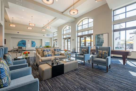 a resident clubhouse with couches chairs and a ping pong table at Deer Creek Apartments, San Ramon, CA