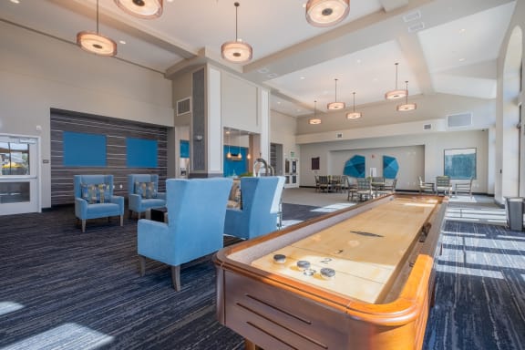 a recreation room with a foosball table and chairs  at Deer Creek Apartments, San Ramon, CA