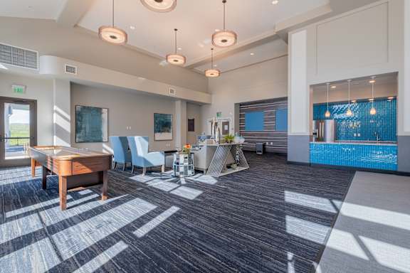 a resident clubhouse with a pool table and chairs at Deer Creek Apartments, San Ramon, CA