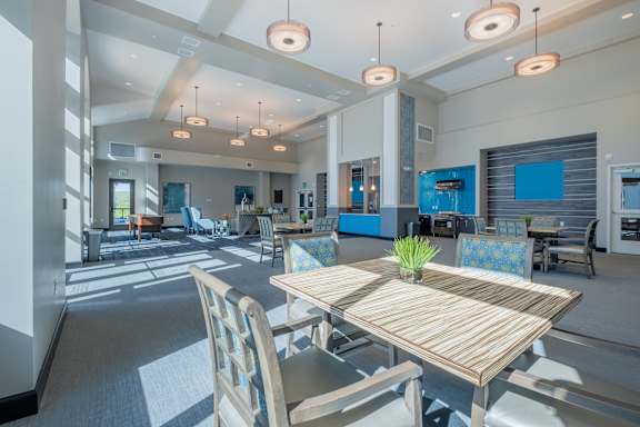 a resident clubhouse with a table and chairs at Deer Creek Apartments, San Ramon, CA