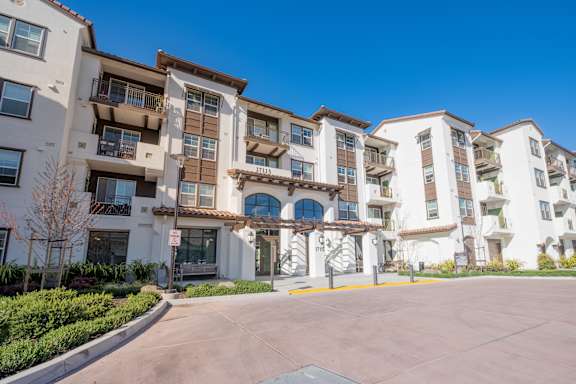 a picture of an apartment building with a parking lot in front of it at Deer Creek Apartments, San Ramon, CA