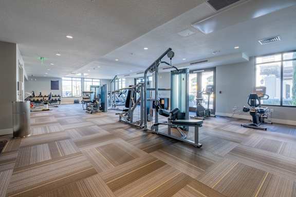 a spacious fitness center with treadmills and other exercise equipment at Deer Creek Apartments, San Ramon, CA