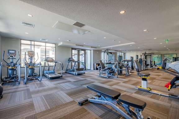 a spacious fitness center with cardio machines and other exercise equipment at Deer Creek Apartments, San Ramon, CA