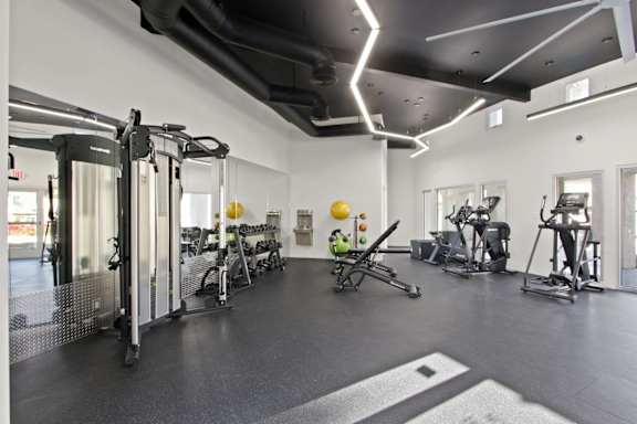 A gym with a variety of exercise equipment  at Harvard Manor, Irvine, CA
