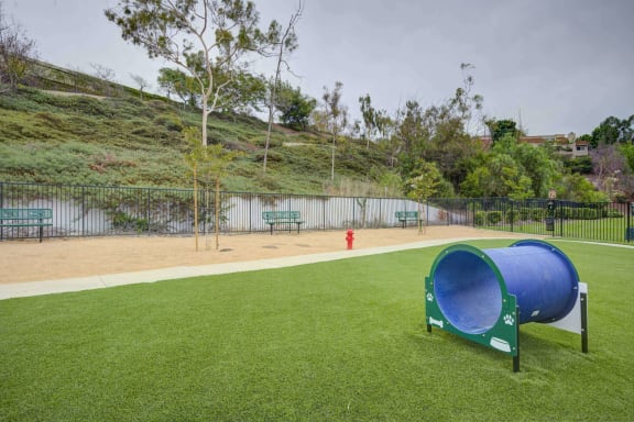 a dog park with a large blue dog kennel and a red fire hydrant at Laguna Gardens Apts., Laguna Niguel, California