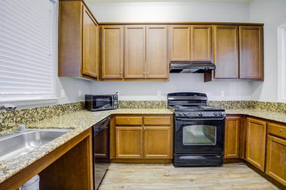 a kitchen with wooden cabinets and granite countertops at Alamo Creek, California, 94506